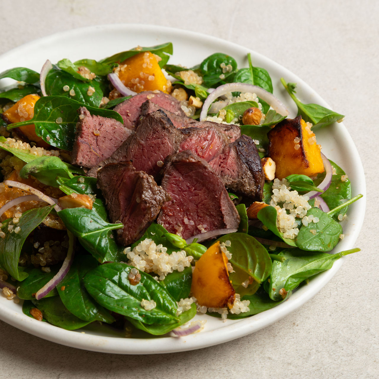 Seared Beef Medallions and Roast Pumpkin Salad with Harissa Dressing